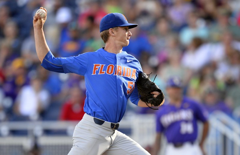 Florida pitcher Brady Singer (51) throws in the first inning of Game 1 of the NCAA College World Series baseball finals against LSU in Omaha, Neb., Monday, June 26, 2017. 