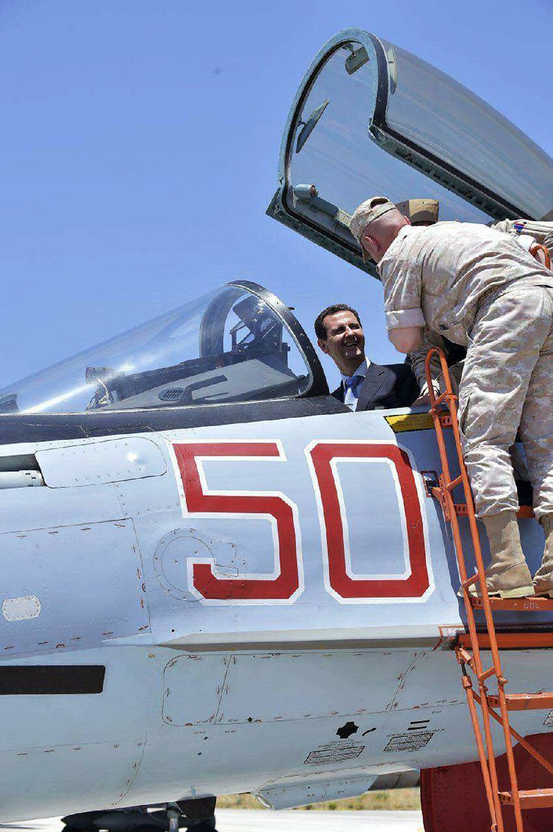 Syrian President Bashar Assad sits in a Russian SU-35 fighter Tuesday as he inspects Russia’s Hmeimim air base at Latakia in southeastern Syria.
