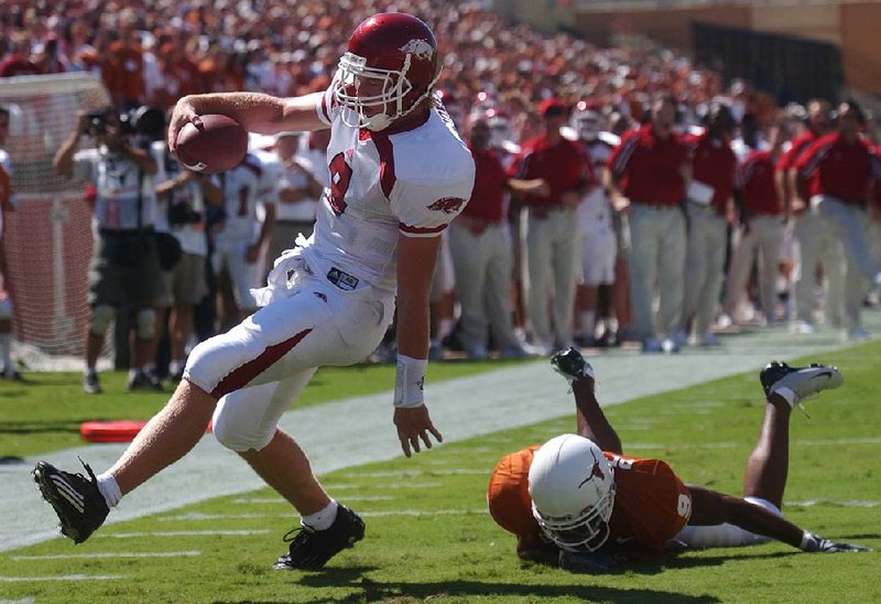 Arkansas quarterback Matt Jones (left) slips into the end zone behind a Texas defensive back during their game Sept. 13, 2003, at Royal-Texas Memorial Stadium in Austin, Texas. Jones ran for 102 yards and passed for 139 yards while scoring 2 touchdowns to carry the Razorbacks to a 38-28 victory over the No. 5-ranked Longhorns.