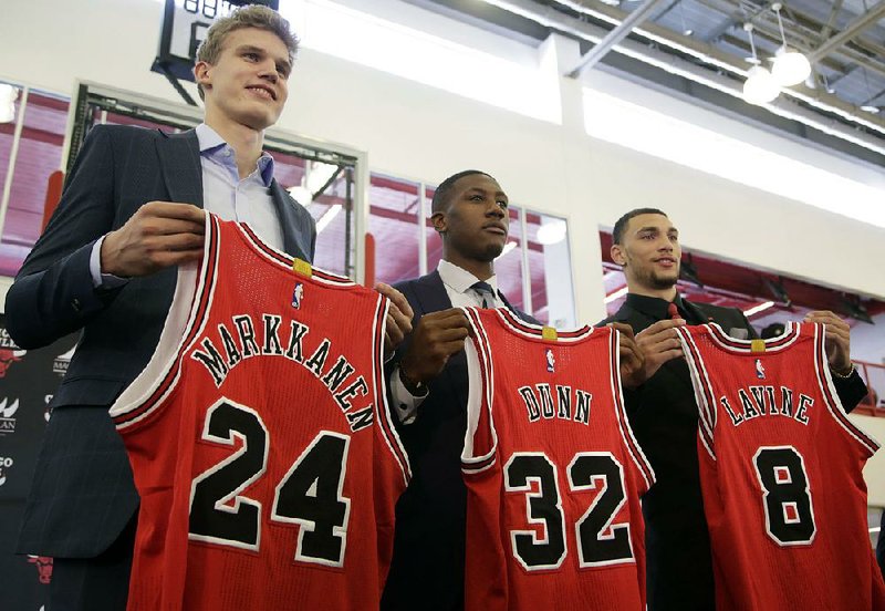 New Chicago acquisitions Lauri Markkanen (left), Kris Dunn (center) and Zach LaVine are introduced during a news conference Tuesday. The Bulls drafted Markkanen No. 7 overall in last week’s NBA draft while Dunn and LaVine were traded from Minnesota for Jimmy Butler. 