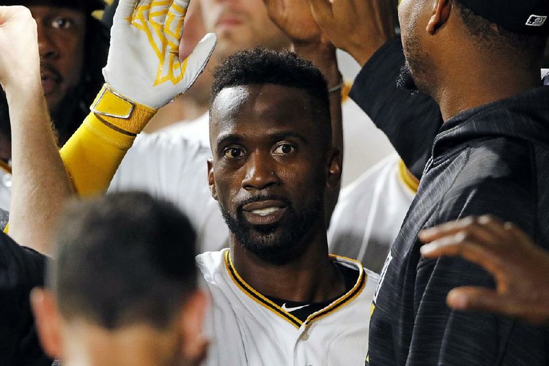 Pittsburgh Pirates' Andrew McCutchen, center, celebrates in the dugout after hitting a two-run home run off Colorado Rockies relief pitcher Jordan Lyles in the eighth inning of a baseball game in Pittsburgh, Tuesday, June 13, 2017. 