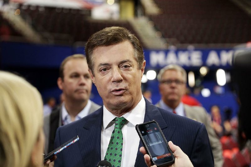 In this July 17, 2016 file photo, then-Donald Trump Campaign Chairman Paul Manafort talks to reporters on the floor of the Republican National Convention, in Cleveland. 