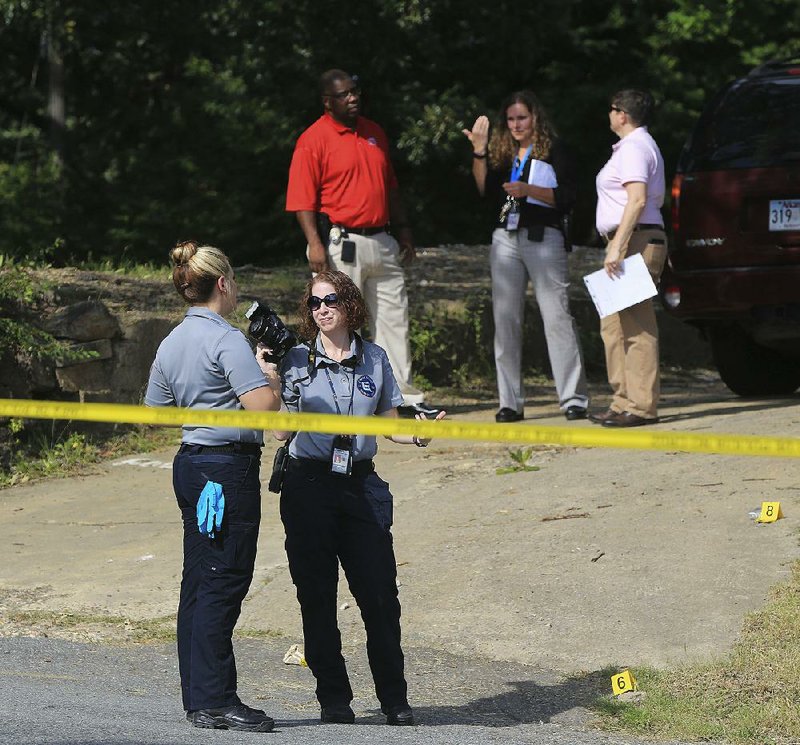 Little Rock police personnel investigate a shooting in which a 7-year-old was injured Tuesday near the intersection of West 12th and Washington streets.