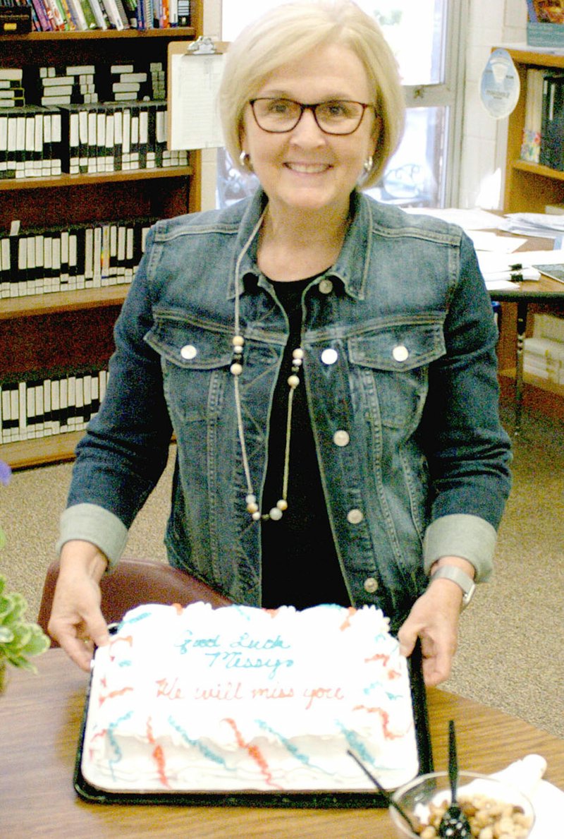 MARK HUMPHREY ENTERPRISE-LEADER/Outgoing Prairie Grove assistant superintendent Missy Hixon was presented with a cake during her last Prairie Grove School Board meeting June 17. Hixon has taken a job as assistant director and teacher center coordinator for Northwest Arkansas Educational Cooperative in Farmington.