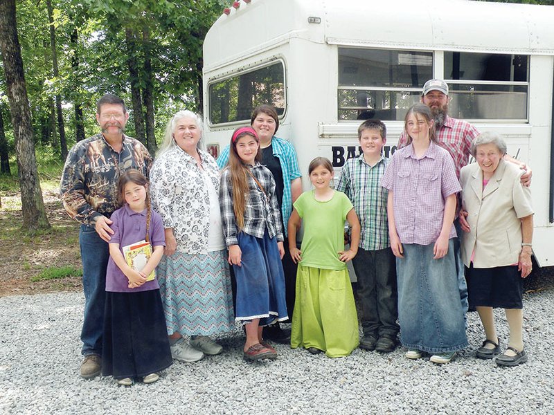 Billy Brewster, left, established a church, Baptist of the Wildwood, in 2008 in Wilburn. His wife, Susan, second from left, teaches in the home-school program at the church. Other members of the Brewster family include Deborah Joy, standing between Billy and Susan; then, from left, front row, Leah, Moriah, Nathanael, Anna and Eunabelle; and back row, Carrie, left, and Isaac.