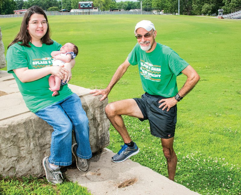 The sixth annual Bad Boy Kids’ Splash and Dash and Bad Boy Adult Super Sprint Triathlon at Lyon College in Batesville will take place July 8. Getting ready for the event are Morgan Winston, executive director of the Ozark Foothills Literacy Project, holding her daughter, Asyln Reed, 6 weeks, and Bruce Oakley, a volunteer who coordinates the run segments for the races. The events will benefit the Ozark Foothills Literacy Project.