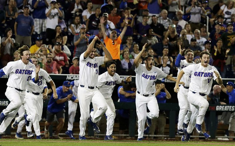 Florida players storm out of the dugout after the Gators defeated LSU on Tuesday night at the College World Series in Omaha, Neb., to win the school’s first national championship in baseball. 