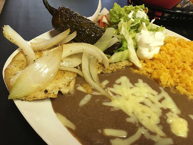 Pollo Asado, with side rice, beans and a salad — plus a really wicked grilled pepper — is one of four meat-based entrees at Bucanas Billar & Taqueria. 