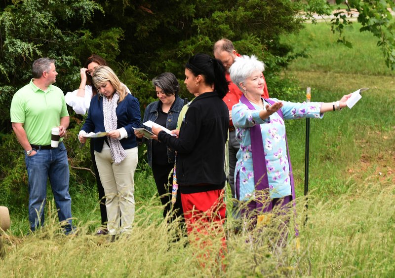 NWA Democrat-Gazette/FLIP PUTTHOFF The Rev. Pamela Cicioni, spiritual director at Highlands Oncology Group in Rogers (right), leads a blessing of the land walk last month at the site of the Healing Gardens of Northwest Arkansas. The Healing Gardens of Northwest Arkansas will host its second annual “Seeds of Hope” summer garden party July 27 at the Barn at the Springs in Springdale.