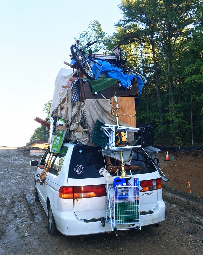 This June 28, 2017, photo provided by New Hampshire State Police trooper Nicholas Iannone shows a vehicle with household goods on its roof, including furniture, boxes and a wheeled basket, after New Hampshire State Police pulled it over on Interstate 93 near Londonderry, N.H.