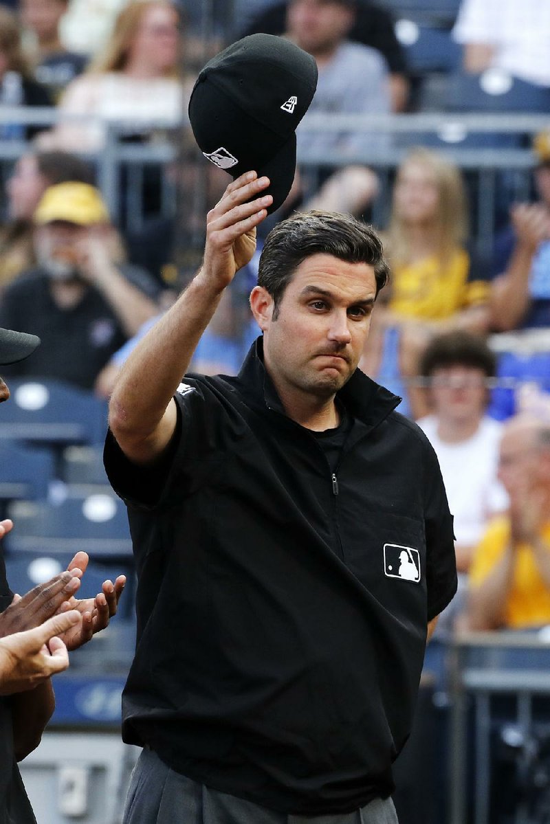 Umpire John Tumpane is recognized before Thursday’s game between the Pittsburgh Pirates and Tampa Bay Rays. On Wednesday, he and two others stopped a woman they suspected was going to jump from a bridge in Pittsburgh.