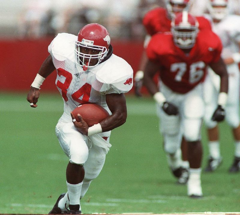 Arkansas running back Madre Hill (left) leaves an Alabama defender behind during the fi rst half of their game in 1995. Hill carried 26 times for 105 yards and caught 1 pass for 15 yards for the Razorbacks, who outscored the Crimson Tide 10-2 in the second half to pull off a 20-19 victory in front of a crowd of 70,123 fans at Bryant-Denny Stadium in Tuscaloosa, Ala.