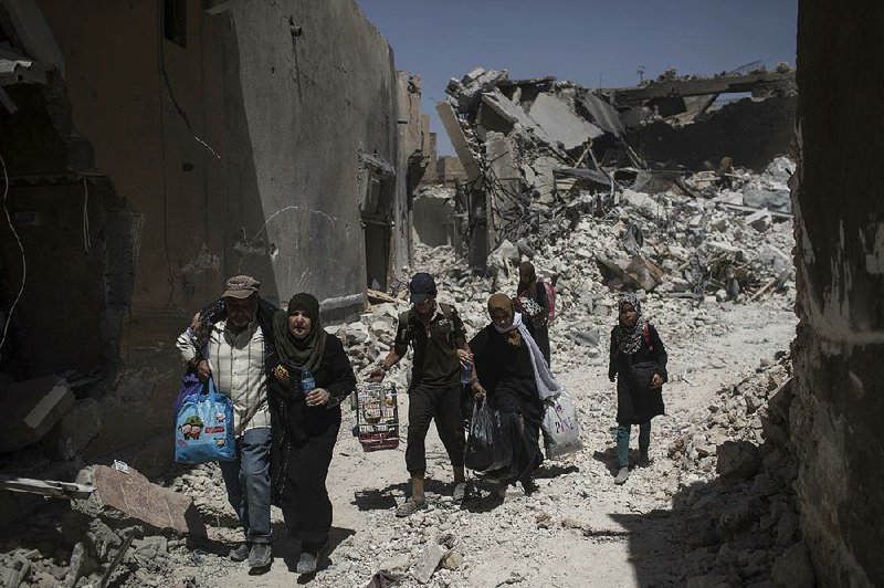 Iraqi civilians flee as Iraqi special forces move toward Islamic State militant positions Thursday in the Old City of Mosul, Iraq.