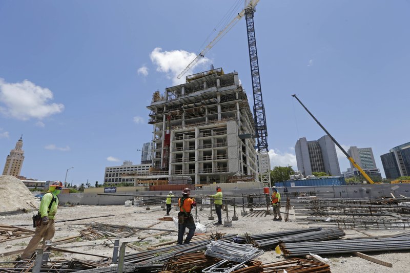 In this Thursday, May 4, 2017, photo, construction workers work on site of an apartment high rise in Miami. On Thursday, June 29, 2017, the Commerce Department issues the final estimate of how the U.S. economy performed in the January-March quarter. (AP Photo/Alan Diaz)