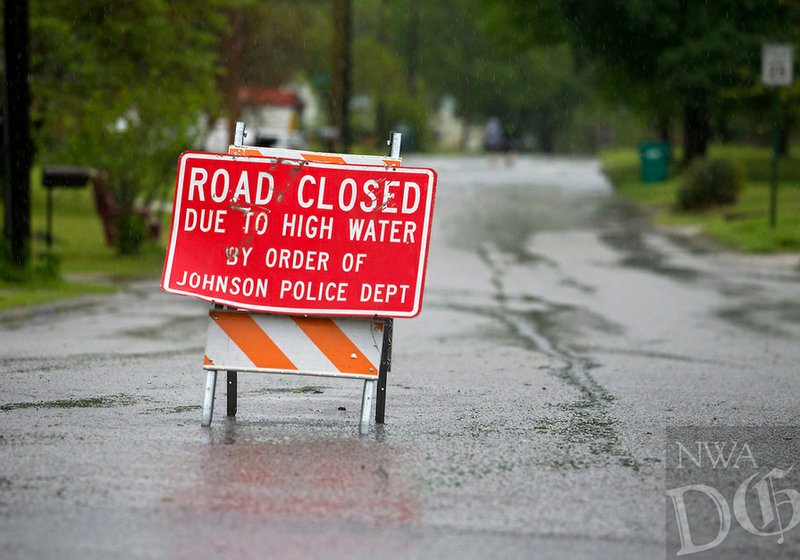 A sign blocks entrance to Ball Street Tuesday, April 26, 2017, due to flooding in Johnson. 