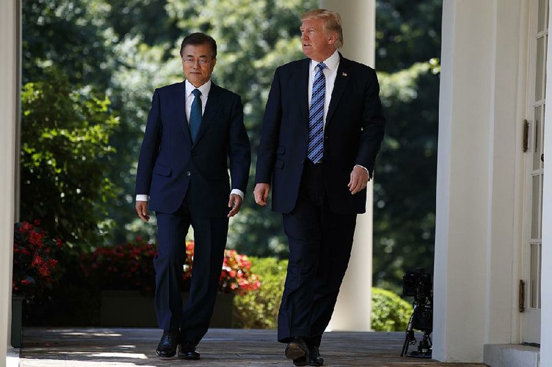 President Donald Trump walks Friday with South Korean President Moon Jae-in to make statements in the Rose Garden at the White House. Trump and Moon avoided any conflict over North Korea, but the two showed little harmony on trade issues. 