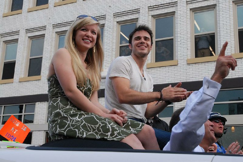 Kris Allen and his wife, Katy, enjoy his homecoming parade in Conway on May 8, 2009. Allen would be named the American Idol Season 8 winner on May 20.