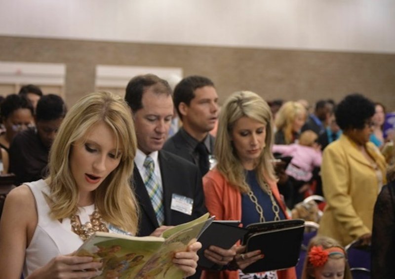 Ally Huckins (left), and her parents, Andy and Melodie Huckins, attend a previous regional convention of Jehovah’s Witnesses at the Fort Smith Convention Center.