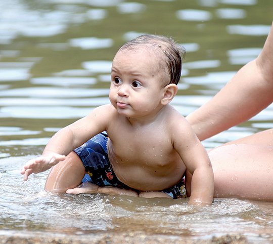 The Sentinel-Record/Mara Kuhn WATER FUN: Joshua Sanchez, 8 months, of Traskwood, plays on the beach at Lake Catherine State Park on Wednesday.