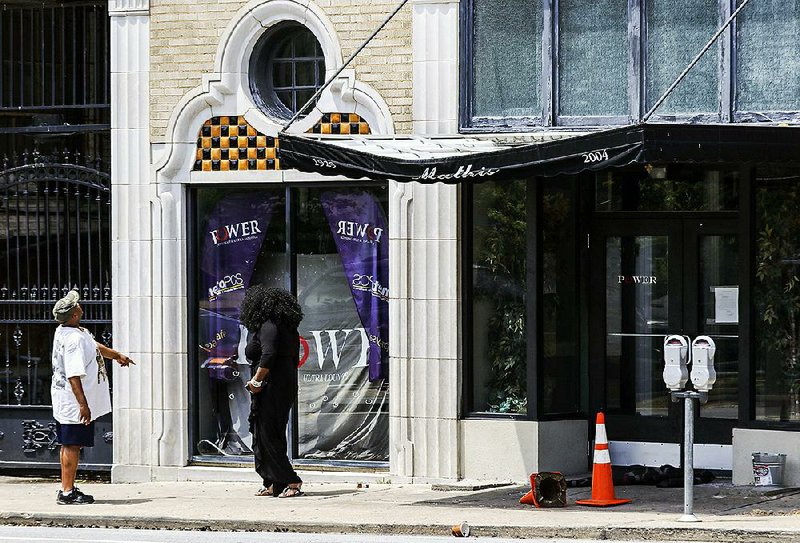 People take a look at the aftermath of the mass shooting at Power Ultra Lounge in downtown Little Rock on Sunday, July 2.