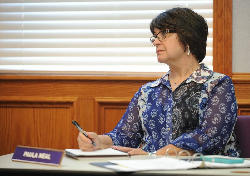 Paula Neal, administrative assistant to the superintendent, records notes June 22 during her final school board meeting before her retirement. Neal served as assistant to four superintendents and served the district for 17 years.