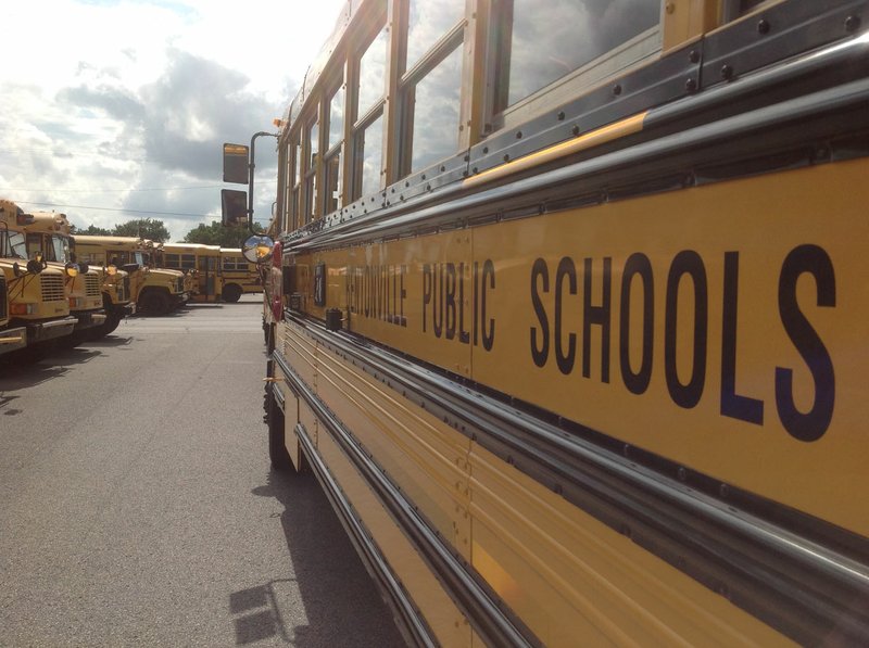 Buses are seen parked Monday outside the Bentonville School District's transportation department on Marquess Drive in Bentonville.