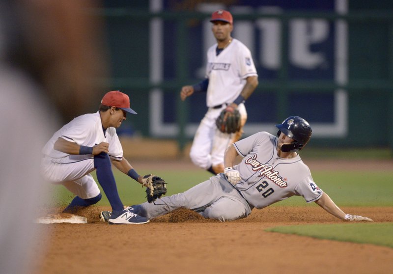 Auston Bousfield, San Antonio center fielder, slides in safe to steal second ahead of a throw to Northwest Arkansas shortstop Nicky Lopez in the seventh inning Monday during the game at Arvest Ballpark in Springdale.