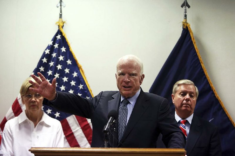 U.S. Sen. John McCain, flanked by Senators Elizabeth Warren and Lindsey Graham, speaks Tuesday during a news conference at the Resolute Support headquarters in Kabul, Afghanistan. “America is the strongest nation on earth,” but “we are not winning, and obviously we need a new strategy to win,” McCain said of the 16-year war in Afghanistan. 