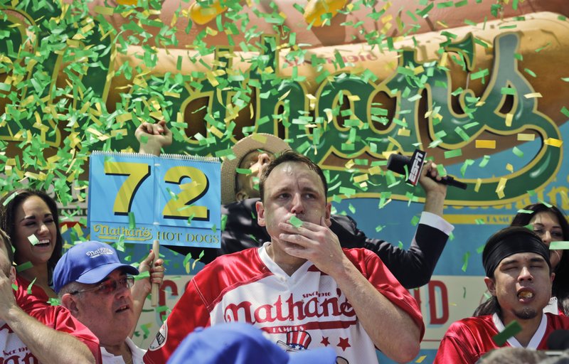 Joey “Jaws” Chestnut celebrates his 10th win in the Nathan’s Famous Hot Dog Eating Contest in Brooklyn, N.Y., on Tuesday. Chestnut ate 72 hot dogs and buns in 10 minutes.