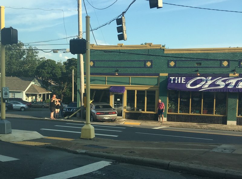 At least one person was said to be injured Tuesday evening after a car crashed into the building that houses the Oyster Bar in Little Rock's Stifft Station neighborhood. Photo by Tim Schulte.