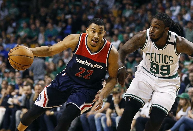  In this April 30, 2017, file photo, Washington Wizards' Otto Porter Jr. (22) drives past Boston Celtics' Jae Crowder (99) during the third quarter of a second-round NBA playoff series basketball game, in Boston. 