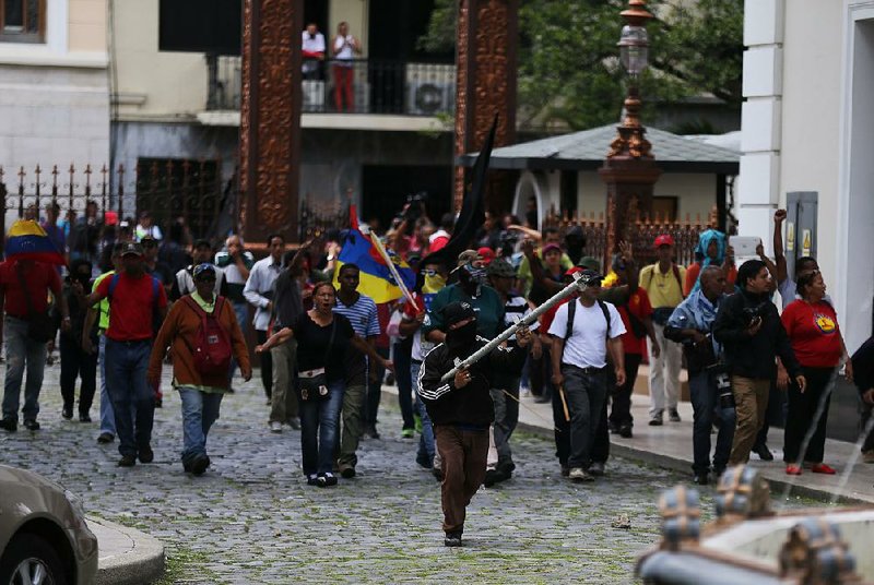 Dozens of government supporters set up a picket outside the National Assembly, heckling lawmakers during a special session coinciding with Venezuela’s independence day on Wednesday in Caracas. 