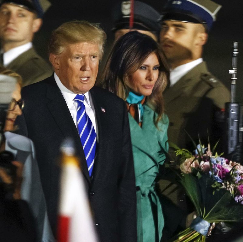 President Donald Trump and his wife, Melania, are greeted by an honor guard Wednesday as they arrive in Warsaw, Poland, for a visit ahead of the Group of 20 meeting in Hamburg, Germany. Trump will give a speech today for which officials have promised to bus in throngs of people. 