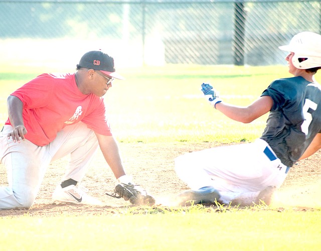 Photo by Rick Peck McDonald County shortstop Omar Manuel tags out a Seneca runner attempting to steal second base during McDonald County&#8217;s 12-0 loss on June 28 at McDonald County High School.