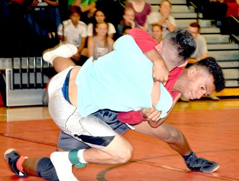 Photo by Rick Peck Trent Alik throws Uriel Lazaro to his back on the way to a pin in the 126-pound weight class at the MCHS summer school intramural wrestling tournament.