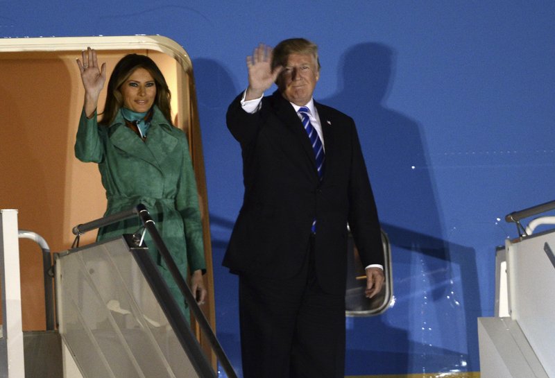 President Trump and the first lady Melania Trump wave from the Air Force One upon their arrival Warsaw, Poland, Wednesday, July 5, 2017. President Donald Trump is back to Europe hoping to receive a friendly welcome in Poland despite lingering skepticism across the continent over his commitment to NATO, his past praise of Russian President Vladimir Putin and his decision to pull the U.S. out of a major climate agreement. (AP Photo/Alik Keplicz)