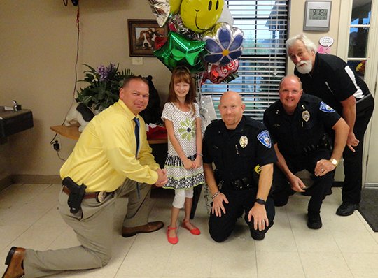 Submitted photo OUTREACH: Hot Springs Animal Services was presented a check for $635 on Wednesday by 10-year-old Kaylie McGough, who raised the money by selling homemade rubber band bracelets for $1 each. Present to accept the donation were, from left, Hot Springs Assistant Police Chief Chris Chapmond, McGough, Officer 1st Class Joey Williams, Police Chief Jason Stachey and Hot Springs Animal Services Director Dan Bugg.