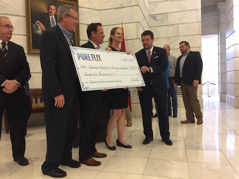 Representatives from PureFlix Entertainment and GND Media Group on Thursday, July 6, 2017, present state Sen. Jason Rapert, R-Bigelow, with a $25,000 check to replace a Ten Commandments monument in Arkansas. 
