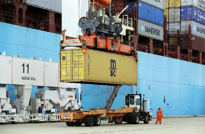 A shipping container is loaded onto a waiting trailer at the Port of Baltimore in this file photo. The trade deficit, the gap between U.S. imports and exports of goods and services, fell to $46.5 billion in May, the Commerce Department said Thursday.