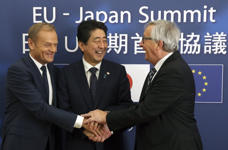 European Council President Donald Tusk, left, Japanese Prime Minister Shinzo Abe, center, and European Commission President Jean-Claude Juncker greet each other prior to a meeting at the Europa building in Brussels Thursday, July 6, 2017. (AP Photo/Francois Walschaerts)