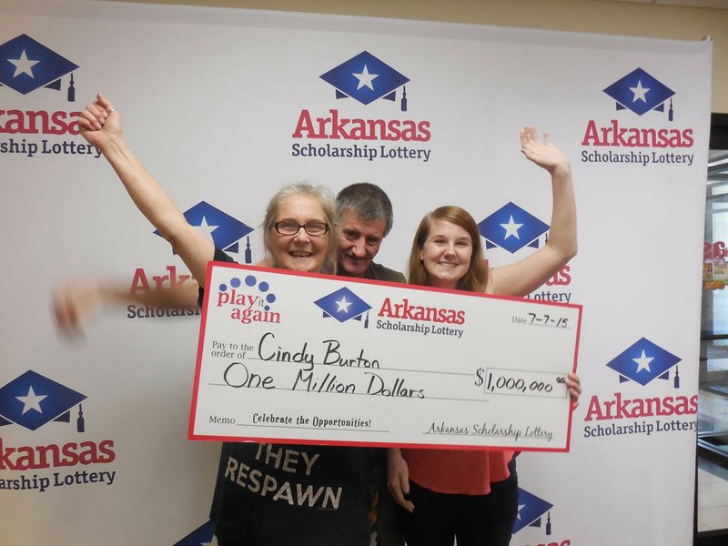 North Little Rock resident Cindy Burton (left) holds a $1 million check with her husband Stacy and daughter Jessica after winning in the Arkansas Scholarship Lottery.