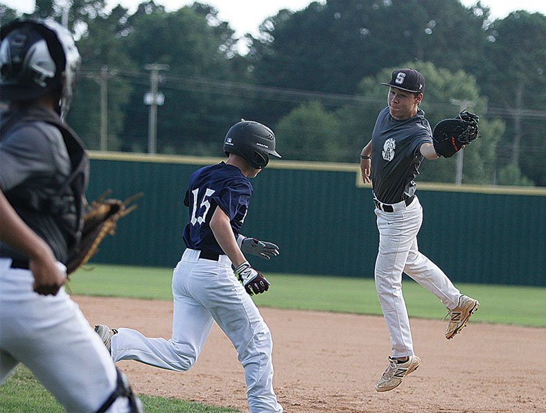 Terrance Armstard/News-Times Smackover's Cody Smith leaps to make the catch at first base as Reid Cates of the El Dorado Drillers runs down the line. Smackover will host the American Legion Area Tournament, beginning today.