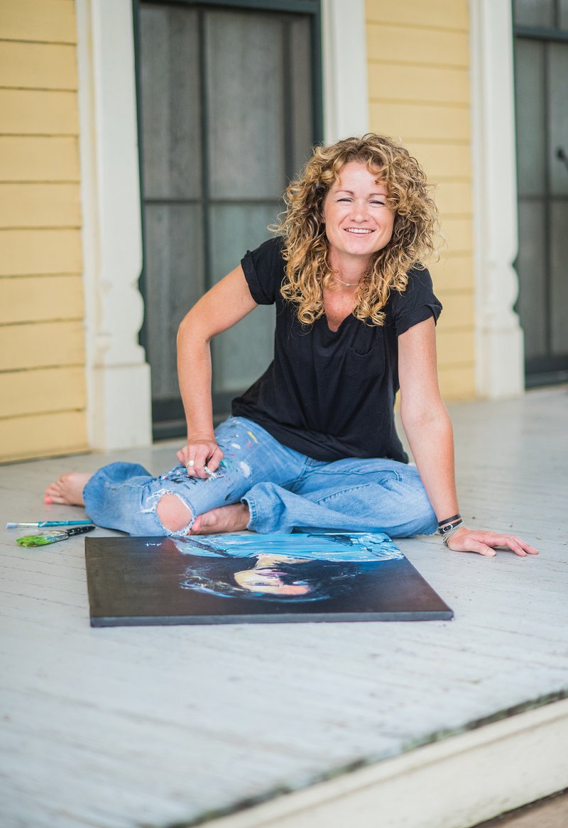 Angela Turney, who has been president of the Searcy Arts Council since October 2015, sits outside of the Searcy Art Gallery with her painting of Chris Cornell.