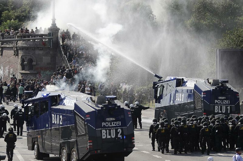 Police use water cannons to clear protesters from a road Friday in Hamburg, Germany. 