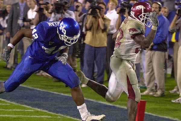 Arkansas fullback DeCori Birmingham, right, outruns Kentucky's Muhammad Abdullah (42) to the endzone to score the final touchdown of the game on a 25-yard run in the seventh overtime at Commonwealth Stadium in Lexington, Ky., Saturday, Nov. 1, 2003. Arkansas won 71-63. (AP Photo/Garry L. Jones)