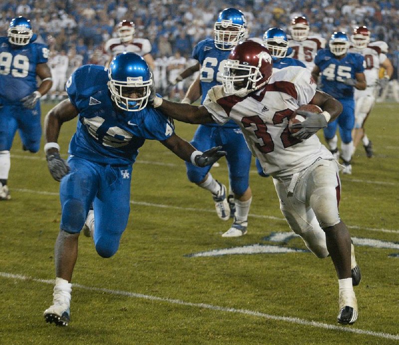 Arkansas’ DeCori Birmingham (right) scored on a 25-yard touchdown run to put the Razorbacks ahead in the seventh overtime against Kentucky on Nov. 1, 2003, in Lexington, Ky. Birmingham rushed for 196 yards and 2 touchdowns on 40 carries to help Arkansas win 71-63.