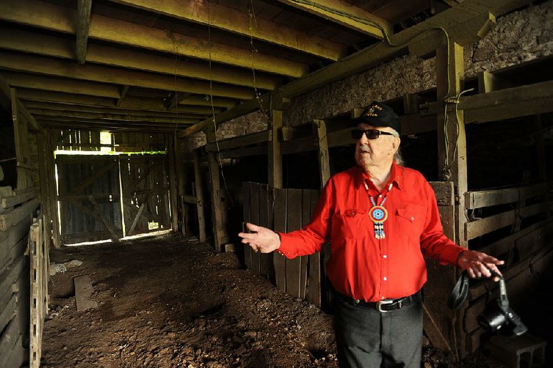 Glenn Jones, a former Benton County historic preservation commissioner, shows off the inside of the pre-Civil War barn at Fitzgerald Station in Springdale.