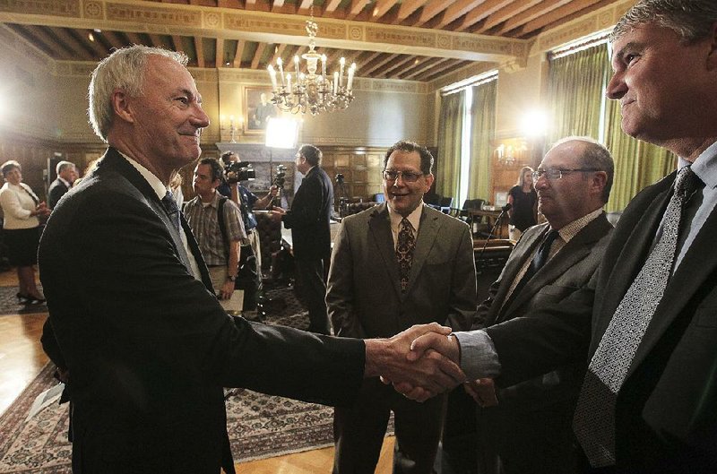 Gov. Asa Hutchinson greets Paul Chapman Jr. during a meeting with state and religious leaders in July 2015 where Hutchinson announced plans for an interfaith summit in August that year.That gave rise to creation of Restore Hope Inc. now headed by Chapman. 