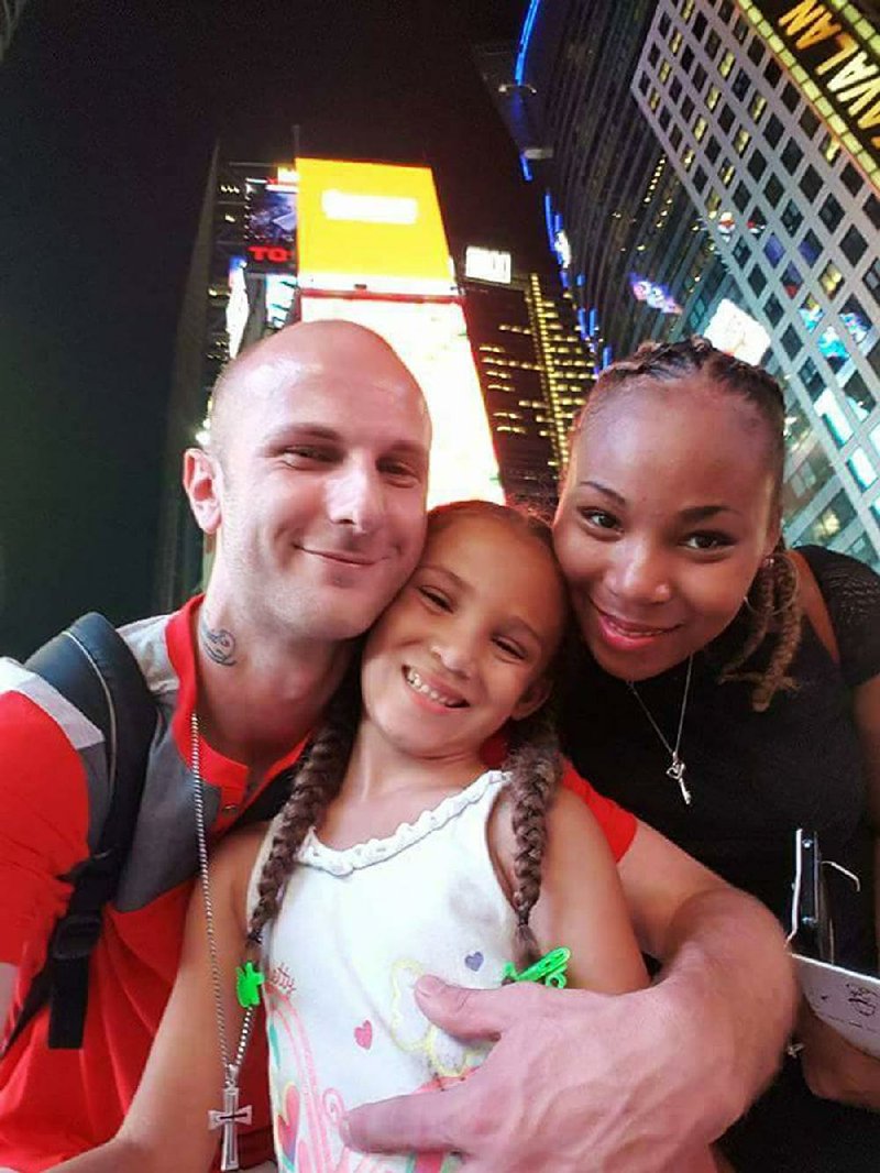 Matthew, Karma and Renata Wezowicz stand in Times Square in New York City at the end of August 2016 while on vacation before Karma started first grade.