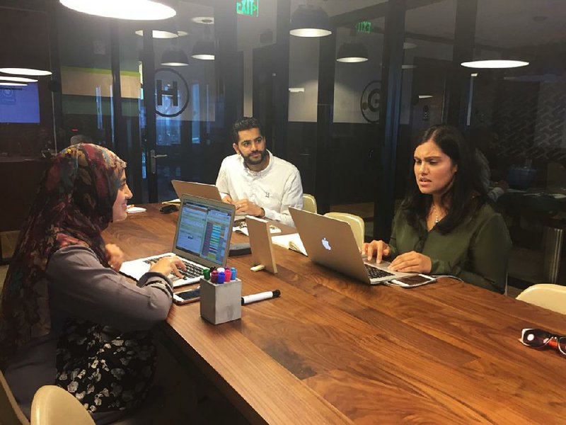 Matchmaker Abeer Ayaz (clockwise from left), Beyond Chai co-founder and CEO Asad Ansari and matchmaker Sadia Khan review possible matches for one of their clients at a team meeting in Tysons Corner, Va. 